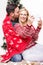 Vertical shot of a happy couple with a red blanket taking a selfie with a Christmas tree