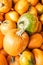 Vertical shot of a heap of pumpkins on the market under the sunlight