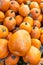 Vertical shot of a heap of pumpkins on the market under the sunlight