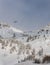 Vertical shot of the helicopter flies over a snow covered mountain in Utah