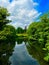 Vertical shot of the Herdentorswallmuhle windmill in Bremen with its reflection on the lake surface