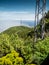 Vertical shot of high mobile cell network towers on the mountain top against clear blue sky