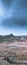 Vertical shot of hilly rocky terrain on a gloomy day, scenic nature view