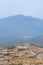 Vertical shot of a Hispanic hiker on top of mount Tlaloc in Mexico