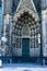 Vertical shot of a historic Cologne Cathedral facade details with carving patterns at daytime