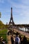 Vertical shot of the historic Eiffel Tower with a crowd of people nearby in Paris, France