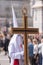 Vertical shot of a hooded penitent holding a cross during the Holy Week in Madrid