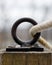 Vertical shot of a hook of a rope on a harbor in the daylight with a blurry background