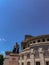 Vertical shot of Hovhannes Tumanyan statue on the background of Opera in daylight