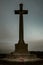 Vertical shot of a huge cross-shaped monument in the Canadian War Cemetery in Groesbeek