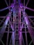 Vertical shot of an illuminated construction of an amusement park attraction