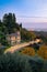 Vertical shot of an illuminated road next to a building in the landscapes of Italy