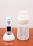 Vertical shot of an infrared thermometer and baby milk bottle