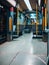 Vertical shot of the inside of an empty train with yellow bars and black and white seats