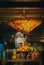 Vertical shot of an interior of a cafe. An umbrella hanging above fruit under dimmed lights