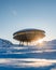 Vertical shot of a interstellar round spaceship on high snowy mountain
