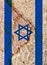 Vertical shot of an Israeli flag on a textured rock background