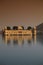 Vertical shot of Jal Mahal in Amer, India in the water under the red sky