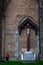 Vertical shot of a Jesus on the cross sculpture in a brick church building in Bruge, Belgium