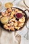 Vertical shot of kaiserschmarrn with torn pancakes, cranberries jam, and apple puree on a table