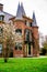 Vertical shot of Kasteel Keukenhof castle with green blooming garden