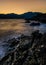 Vertical shot of the Kotor Bay with mountains in the distance at sunrise in Montenegro