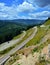 Vertical shot of a landscape and the Transrarau road from the Rarau mountains in Romania