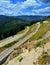 Vertical shot of a landscape and the Transrarau road from the Rarau mountains in Romania