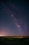 Vertical shot of a landscape under the magical starry sky at night