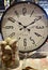 Vertical shot of a large clock face and a glass jar with decorative shells for interior decoration