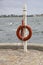 Vertical shot of a lifeguard ring on a pipe surrounded by the sea in Fredericia, Denmark