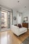 Vertical shot of a living room with a balcony with wooden shutters,