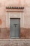 Vertical shot of a locked wooden door surrounded by ornamental carvings