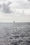 Vertical shot of a lone sailboat on the sea