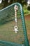 Vertical shot of a lost pacifier with a neck-chain on a park bench