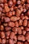 Vertical shot of lots of tasty nutritious red jujube fruits