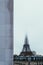 Vertical shot of the lower part of the famous Eiffel tower with the top covered with fog