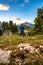 Vertical shot of a male hiker looking at the sunset from the Langkofel Saslonch Mountain