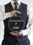 Vertical shot of a man holding a circle with the words Opportunity and Risk written on it