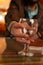 Vertical shot of a man holding an empty goblet glass on a smooth surface