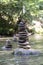 Vertical shot of many stone pyramids balanced on a river water