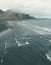 Vertical shot of a mesmerizing seascape surrounded by foggy cliffs