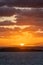 Vertical shot of a mesmerizing sunrise in Brittany beach