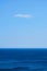 Vertical shot of a mesmerizing tranquil ocean under the blue sky