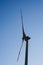 Vertical shot of the metallic wind engine against the blue sky