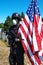 Vertical shot of a military statue with a protective mask and American flag