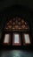 Vertical shot of a mosaic on the windows of a dark building, yazd, Iran