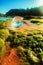 Vertical shot of a mossy seashore with a crystal ball near a blue sea