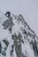 Vertical shot of a mountain climber climbing the Alps in Mont Blanc Massif