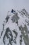 Vertical shot of a mountain climber climbing the Alps in Mont Blanc Massif